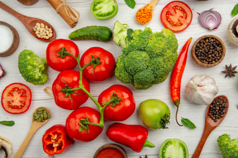 Vibrant assortment of fresh vegetables arranged on a rustic table, symbolizing hormone-balancing Indian superfoods essential for new moms' diets
